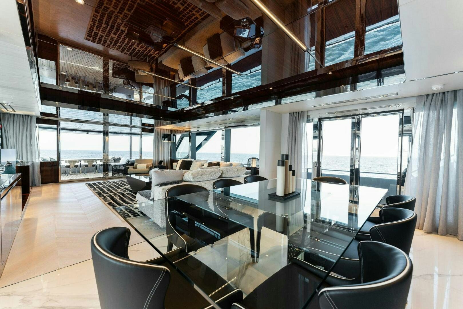 a room with a large window and a table with chairs aboard CHOP CHOP Yacht for Sale