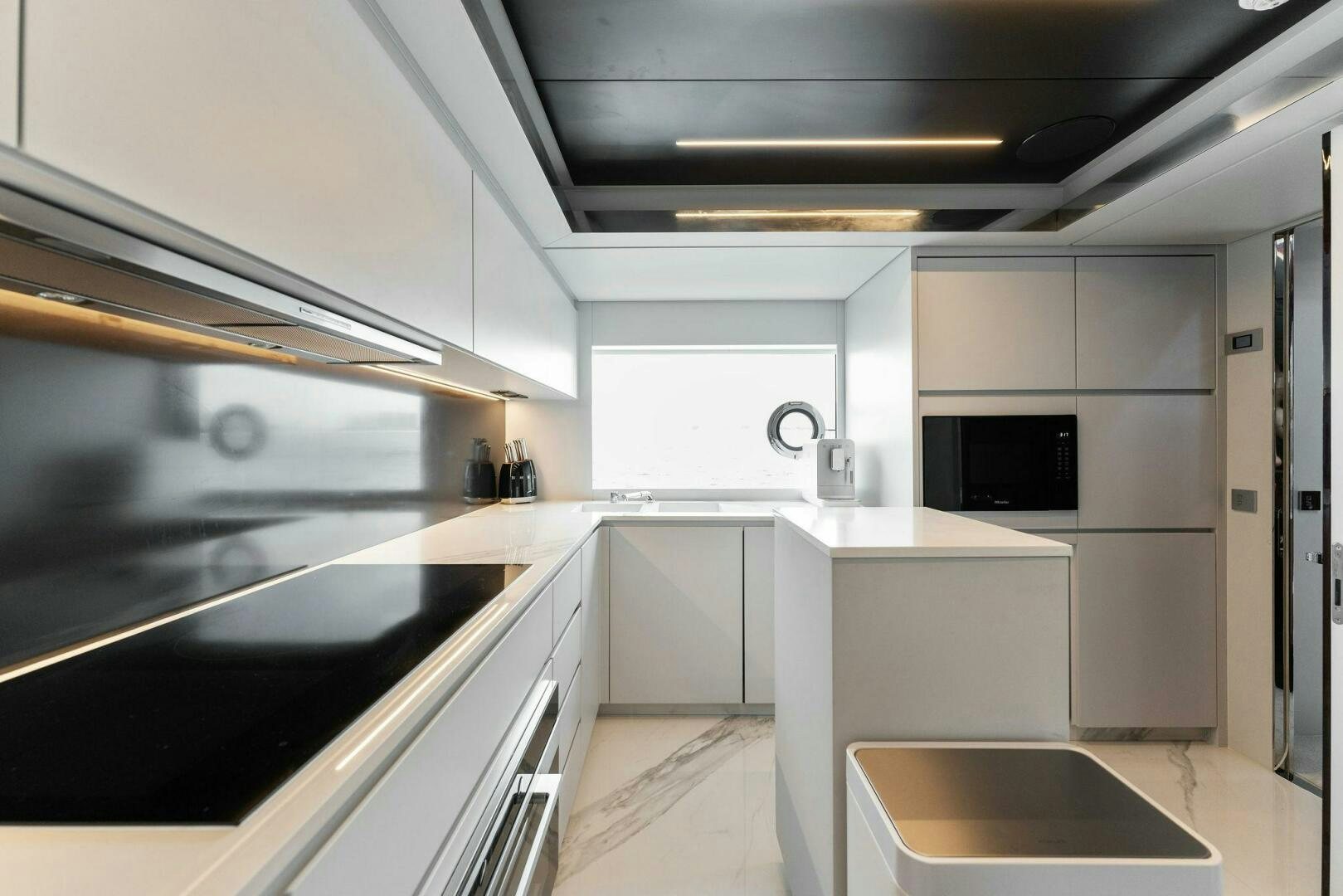 a kitchen with white cabinets aboard CHOP CHOP Yacht for Sale