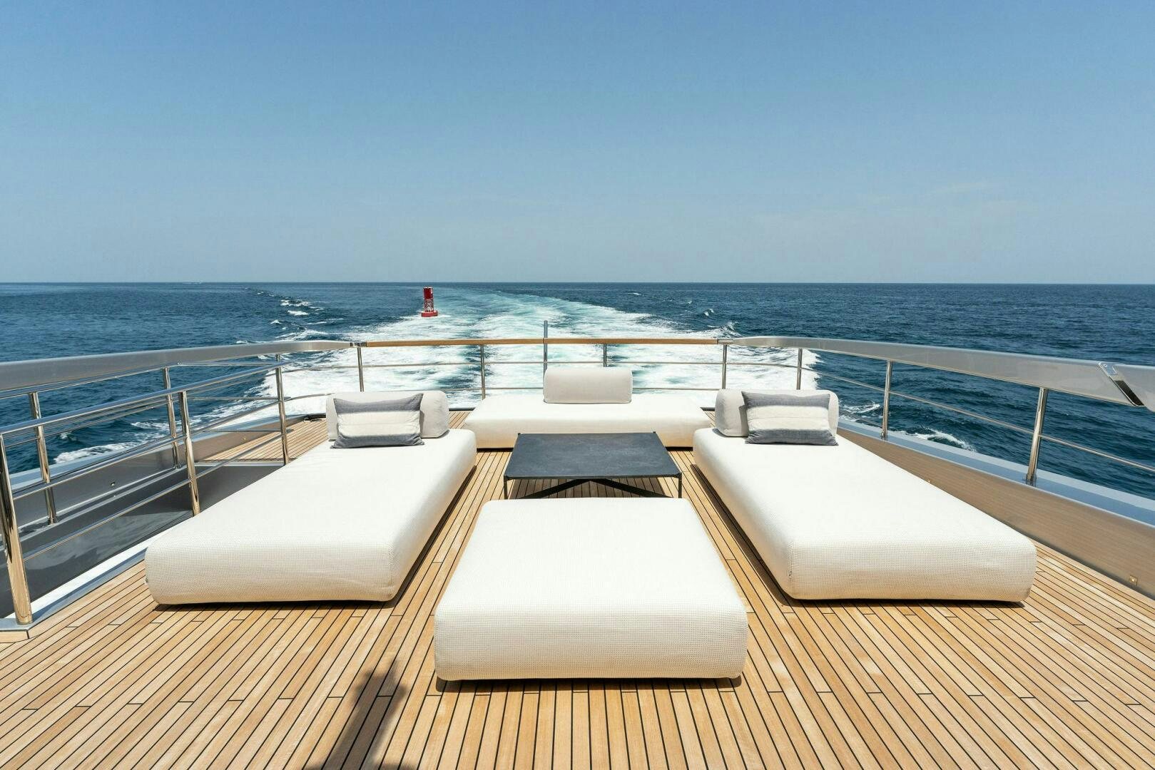 a deck with chairs on it by the water aboard CHOP CHOP Yacht for Sale