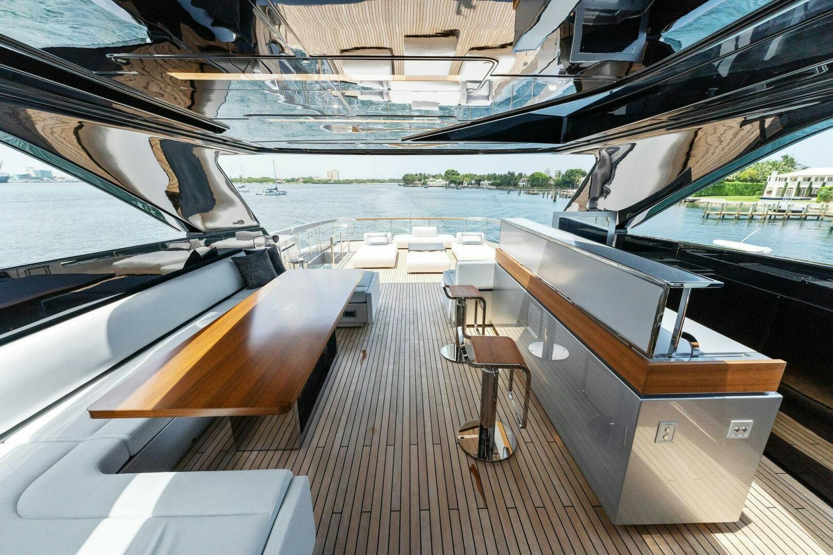 a deck with a wood deck and a view of a lake aboard CHOP CHOP Yacht for Sale
