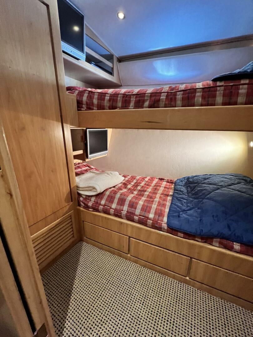 a room with a bed and a wood door aboard GOOD KARMA Yacht for Sale