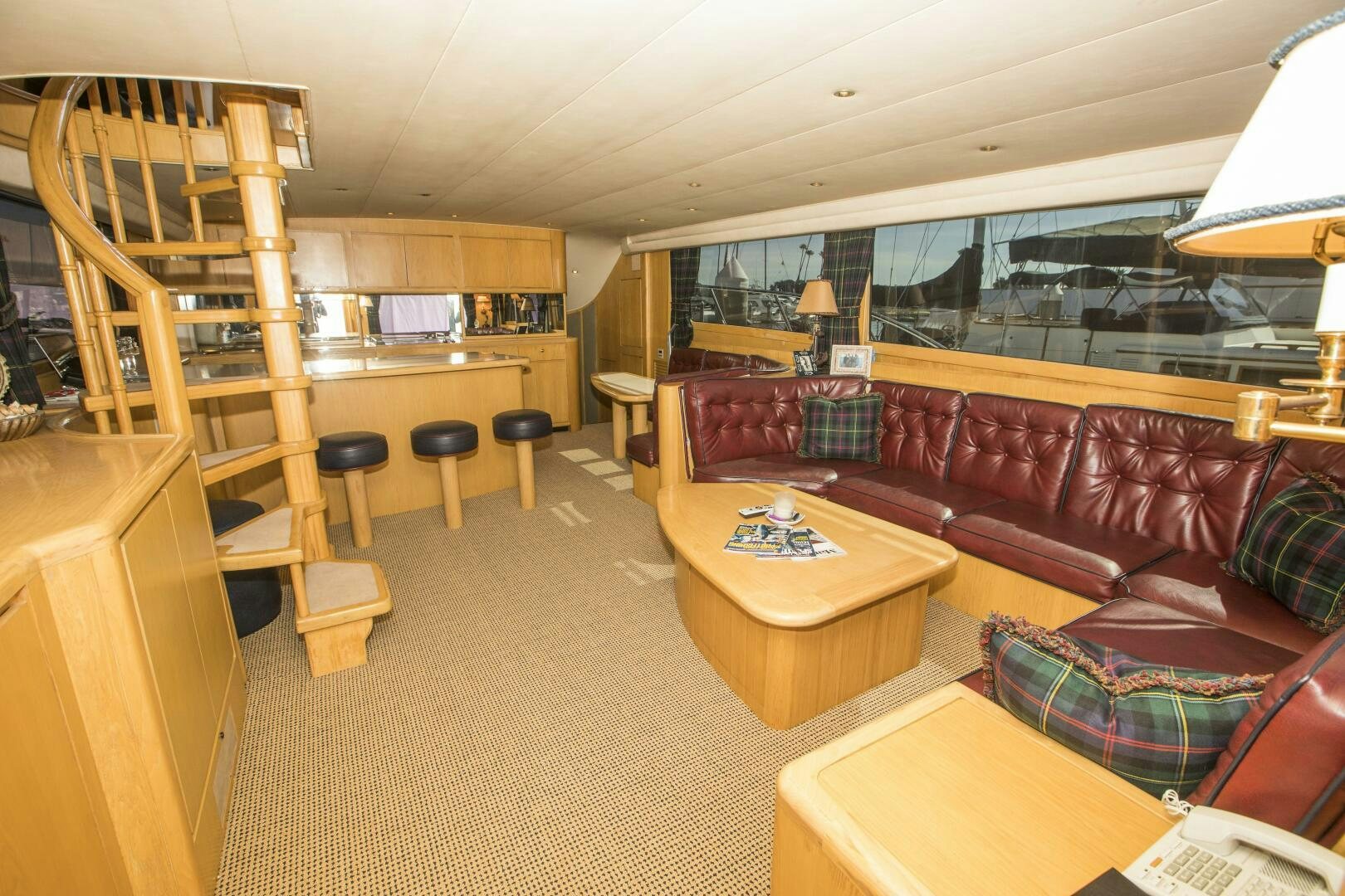 a living room with a staircase aboard GOOD KARMA Yacht for Sale
