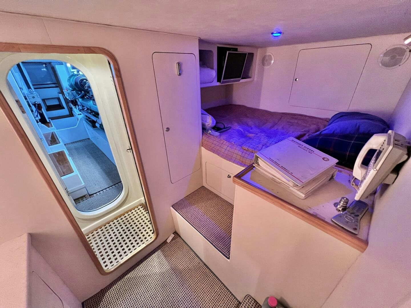 a room with a bed and a desk aboard GOOD KARMA Yacht for Sale
