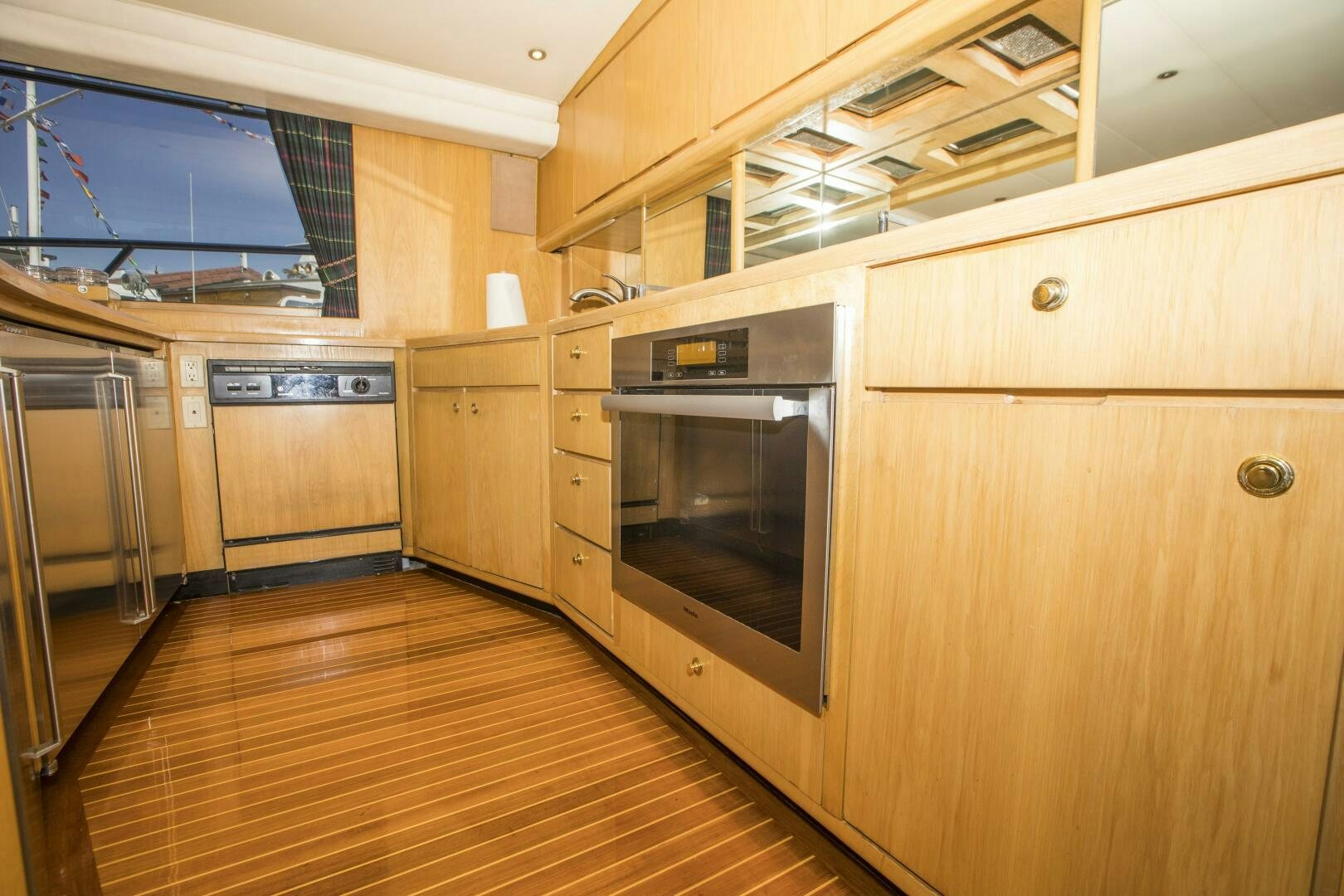 a kitchen with wooden cabinets aboard GOOD KARMA Yacht for Sale