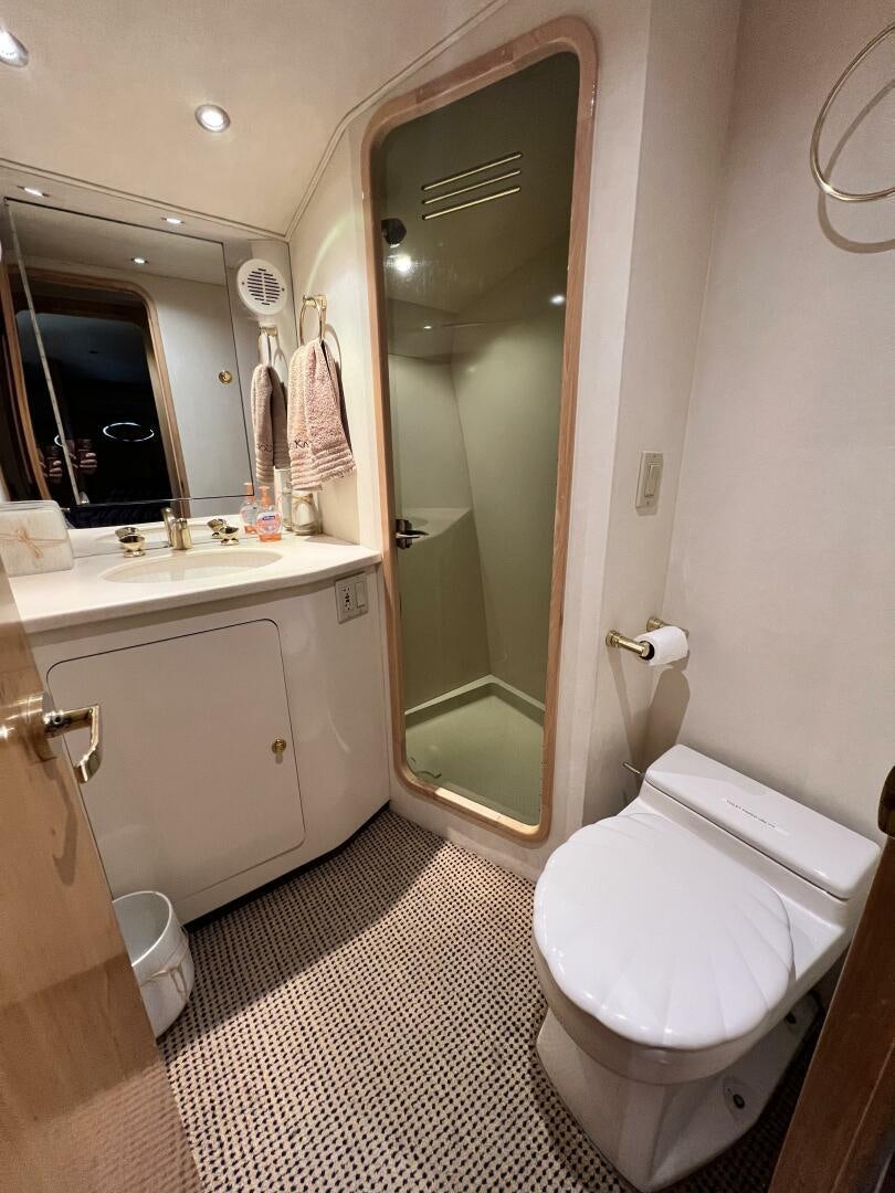 a bathroom with a toilet and a sink aboard GOOD KARMA Yacht for Sale