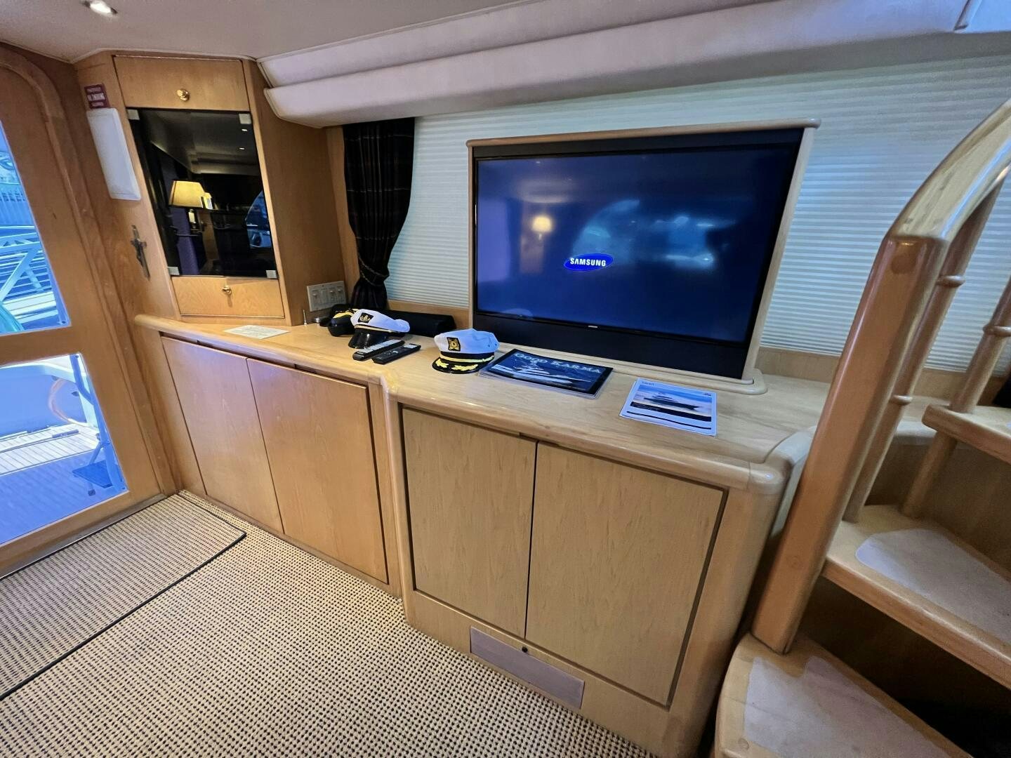 a room with a tv and a desk aboard GOOD KARMA Yacht for Sale