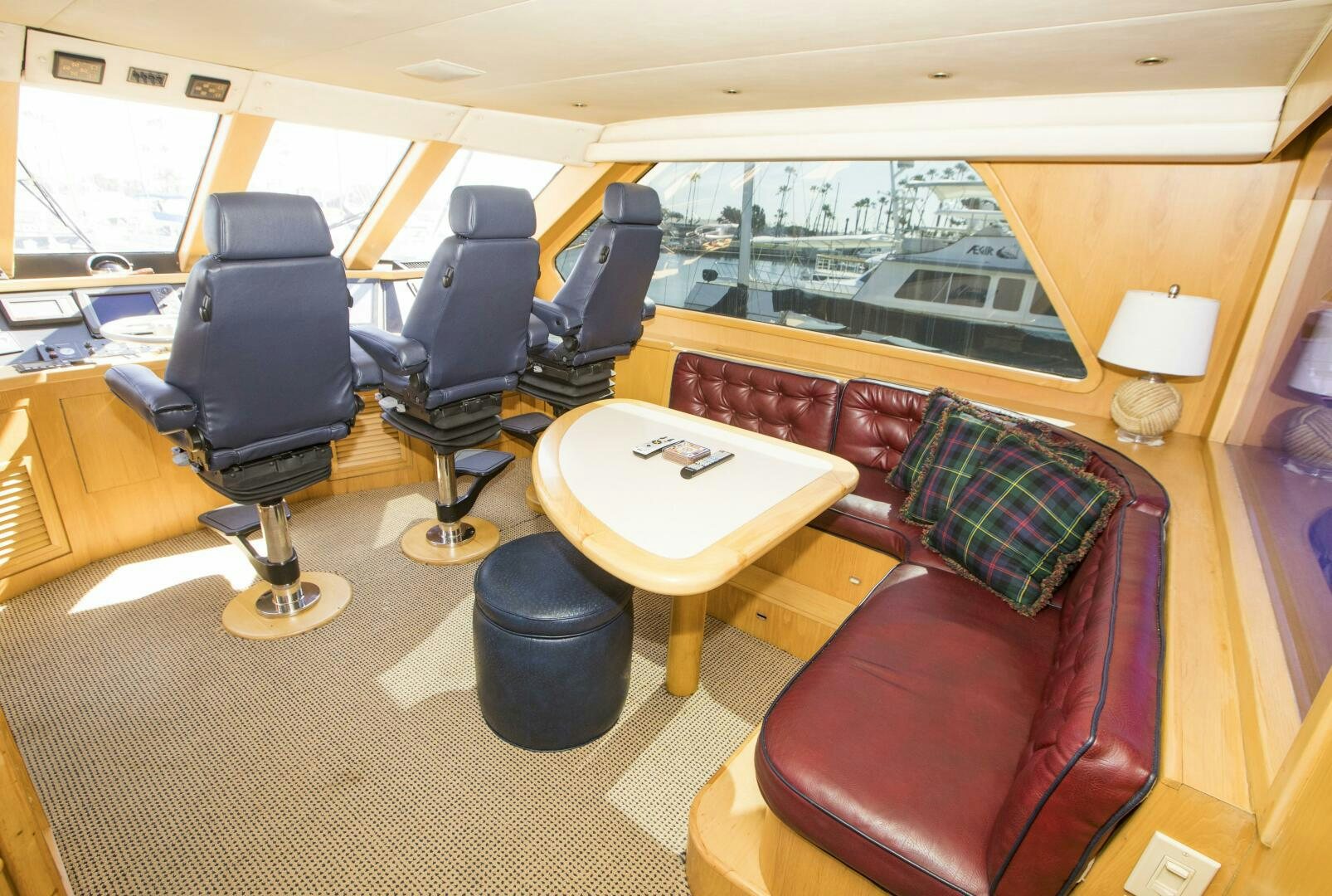 a room with a couch and a table and chairs aboard GOOD KARMA Yacht for Sale