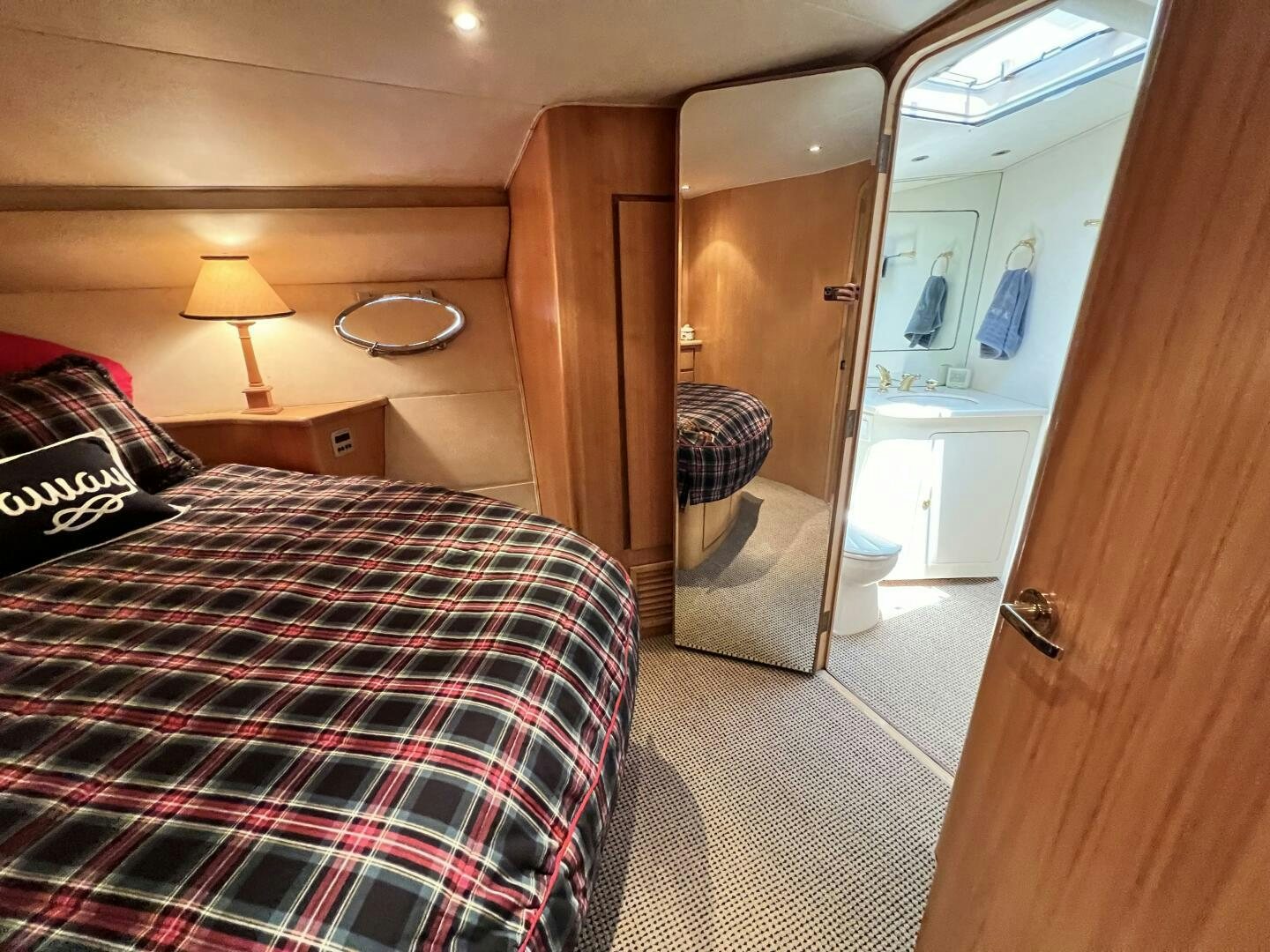 a bedroom with a bed and a mirror aboard GOOD KARMA Yacht for Sale