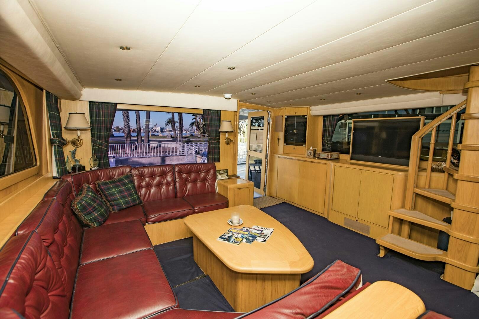 a living room with a table and couches aboard GOOD KARMA Yacht for Sale