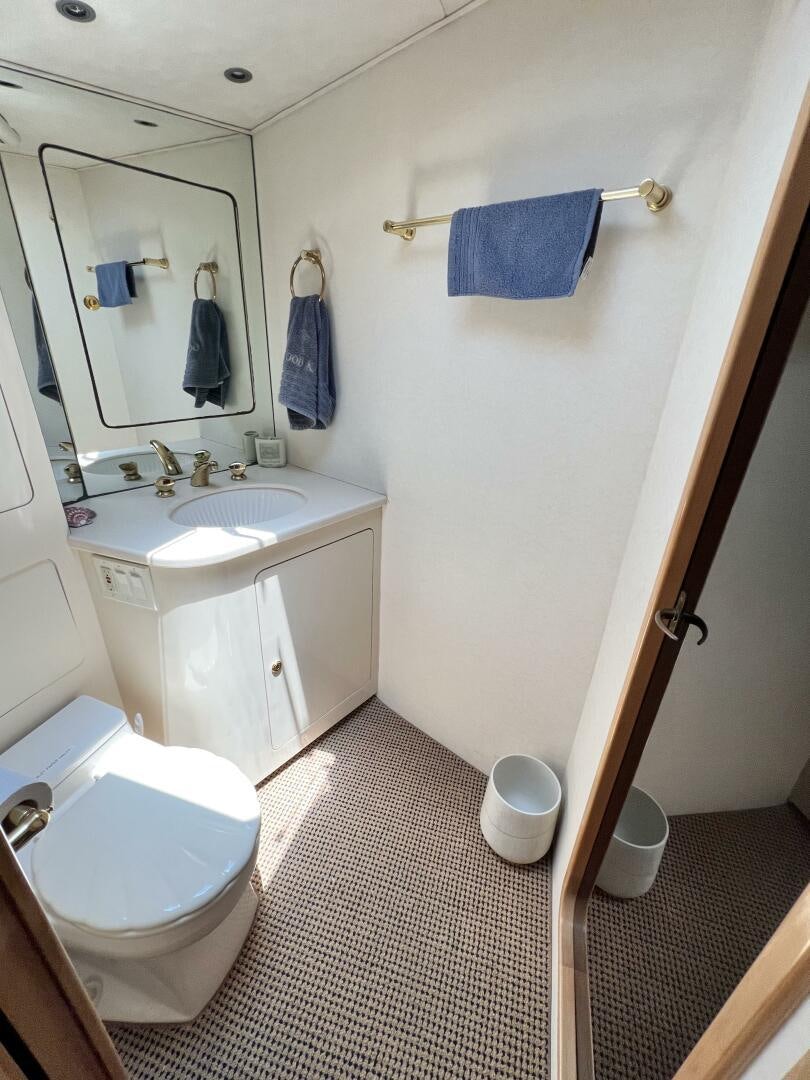 a bathroom with a toilet and sink aboard GOOD KARMA Yacht for Sale