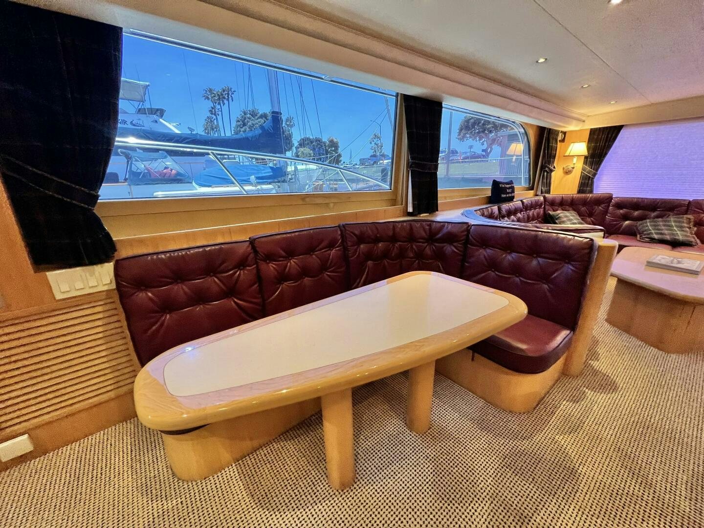 a living room with a couch and a tv aboard GOOD KARMA Yacht for Sale