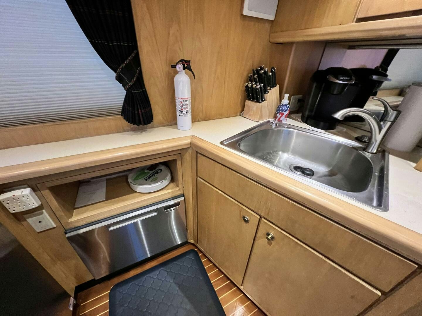 a kitchen with a sink and a window aboard GOOD KARMA Yacht for Sale