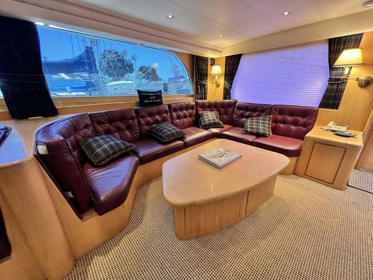 a living room with a large sofa aboard GOOD KARMA Yacht for Sale