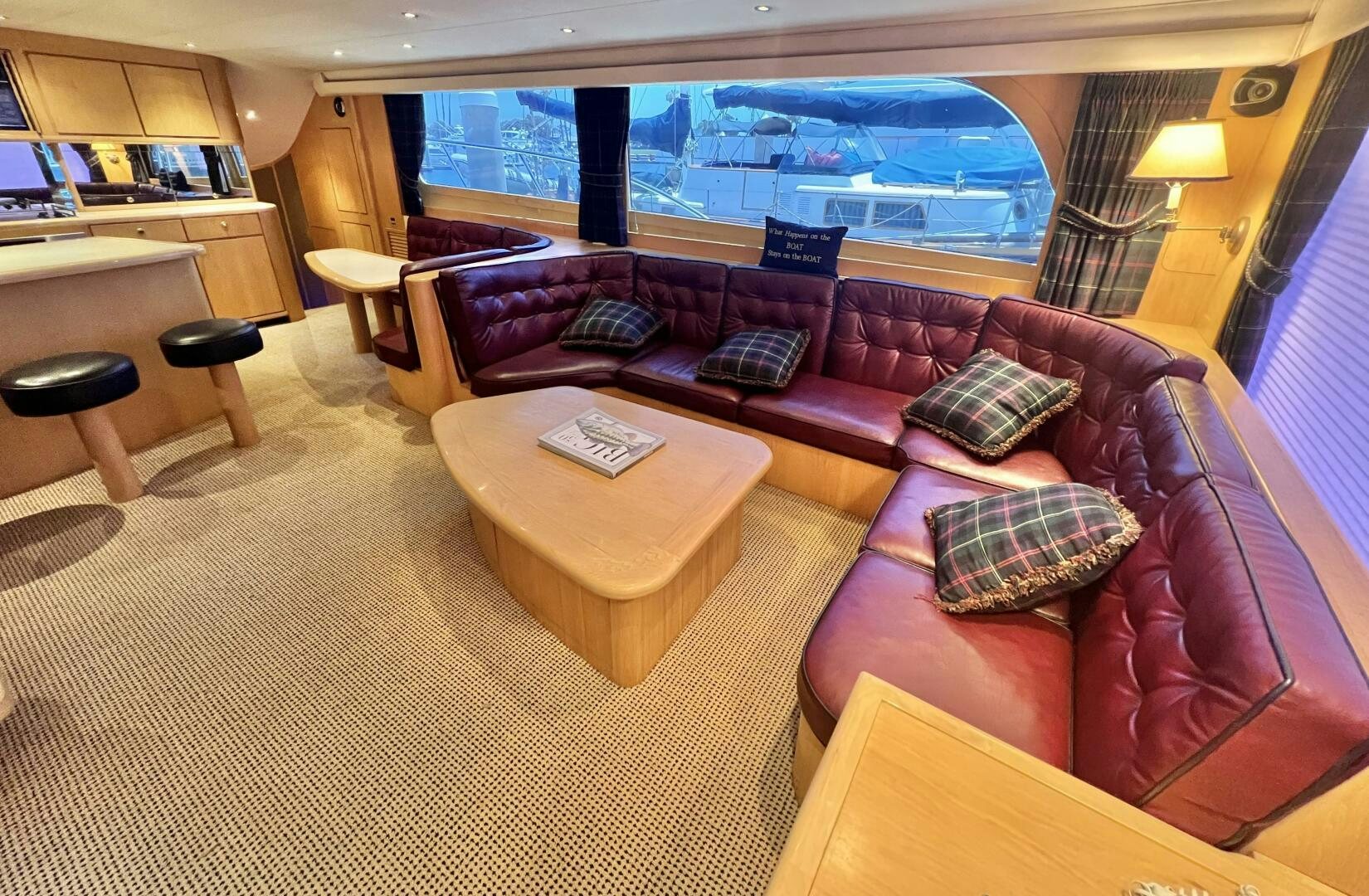 a living room with a large sofa aboard GOOD KARMA Yacht for Sale