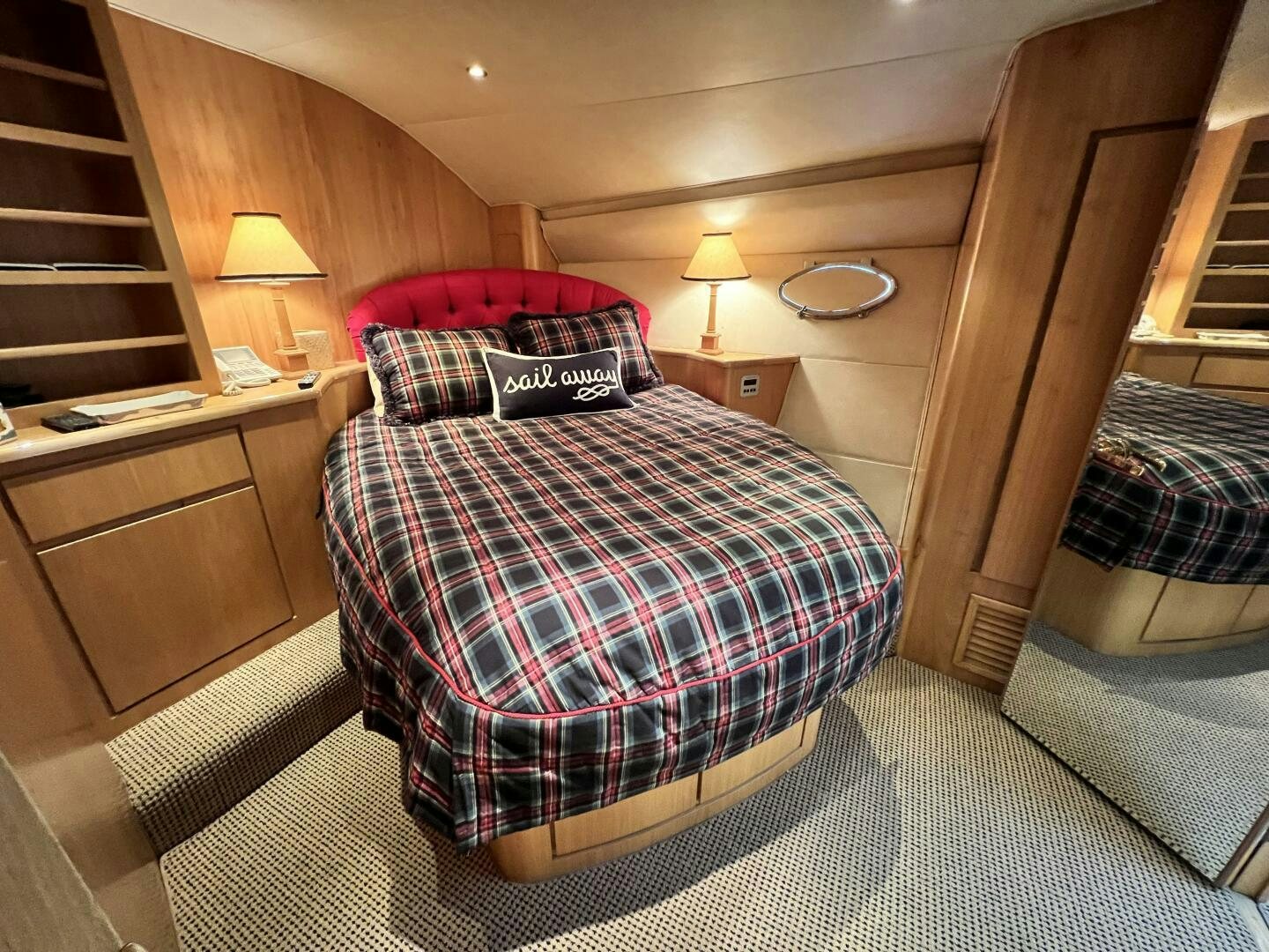 a bed with a red pillow aboard GOOD KARMA Yacht for Sale