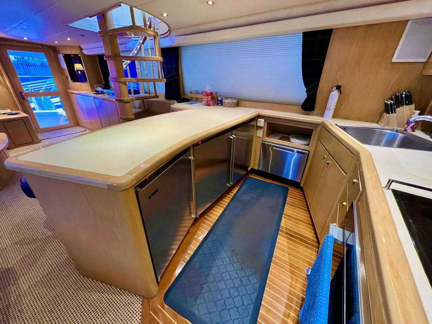a kitchen with a blue counter aboard GOOD KARMA Yacht for Sale
