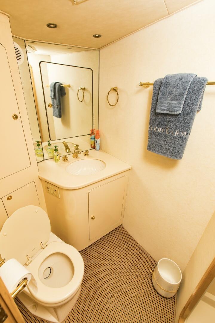 a bathroom with a toilet and sink aboard GOOD KARMA Yacht for Sale