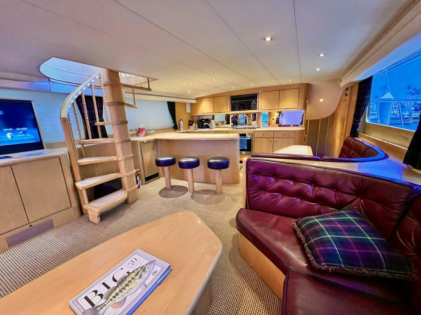 a living room with a ladder aboard GOOD KARMA Yacht for Sale