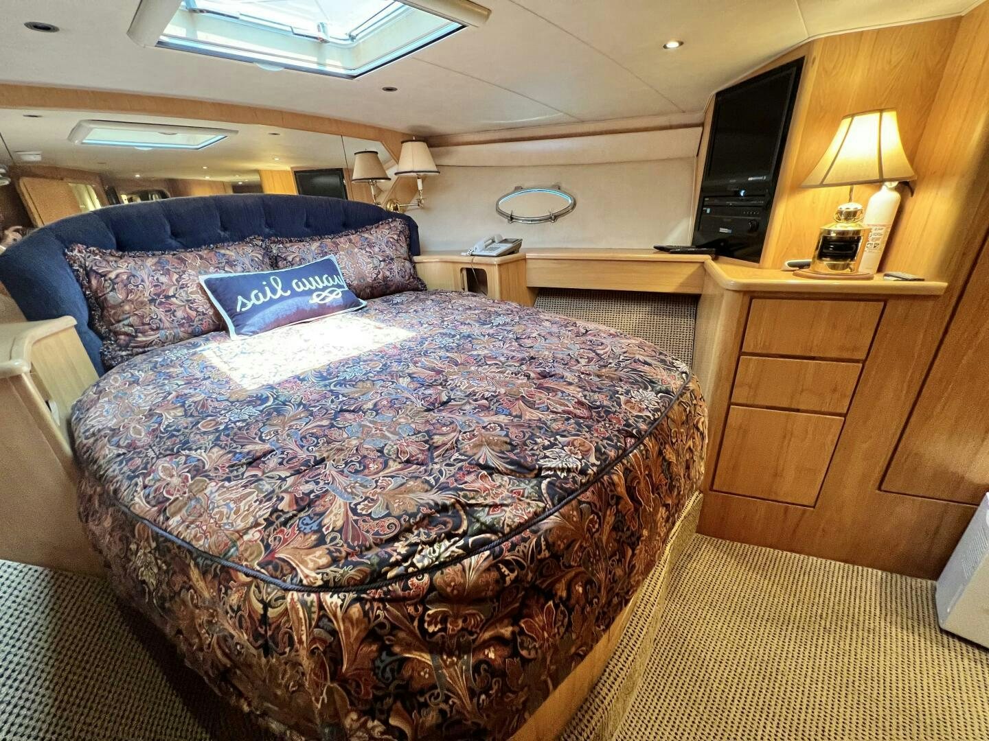 a bedroom with a bed and a tv aboard GOOD KARMA Yacht for Sale