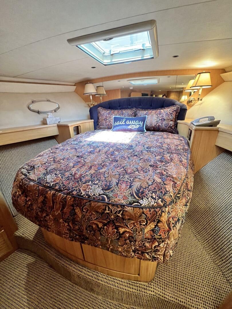 a bed with a blue comforter aboard GOOD KARMA Yacht for Sale