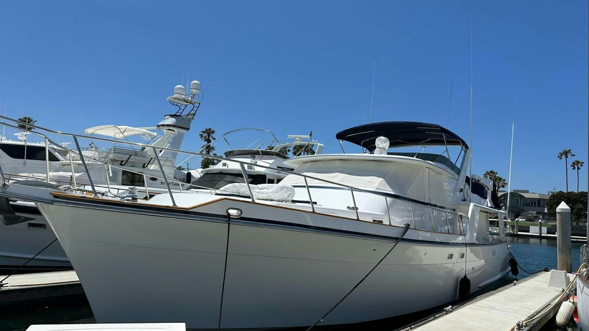 a large white yacht docked aboard HAPPY DAYS Yacht for Sale