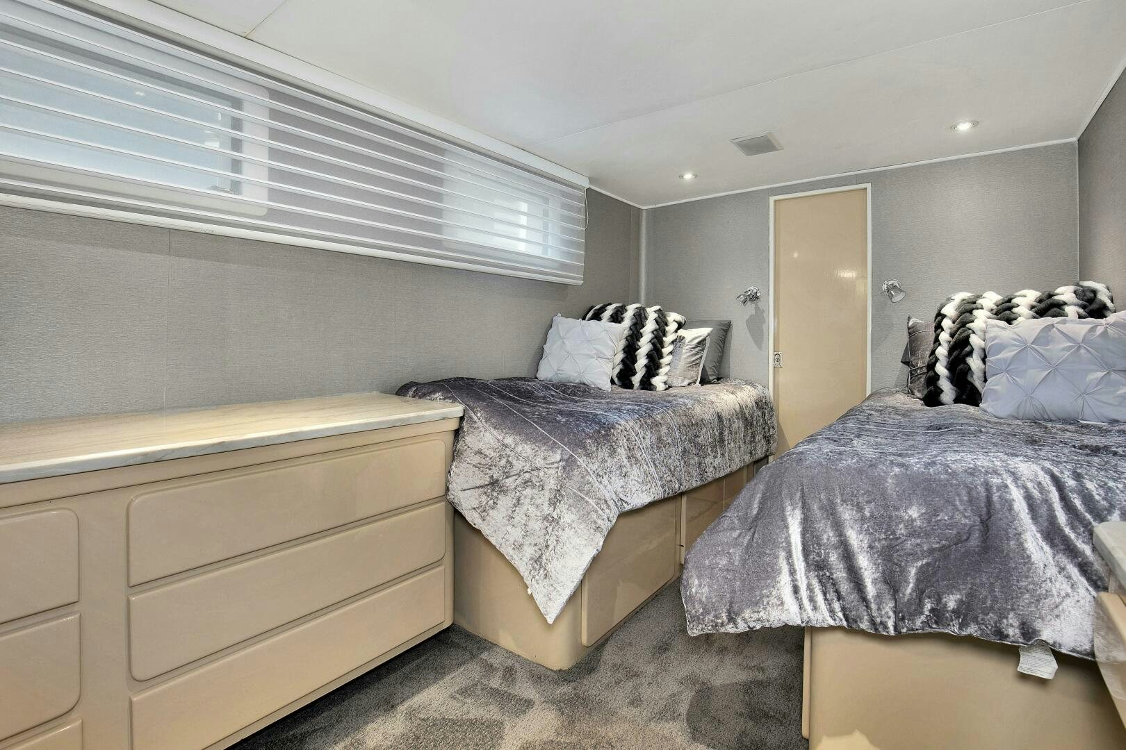 a bedroom with two beds aboard LADY P Yacht for Sale