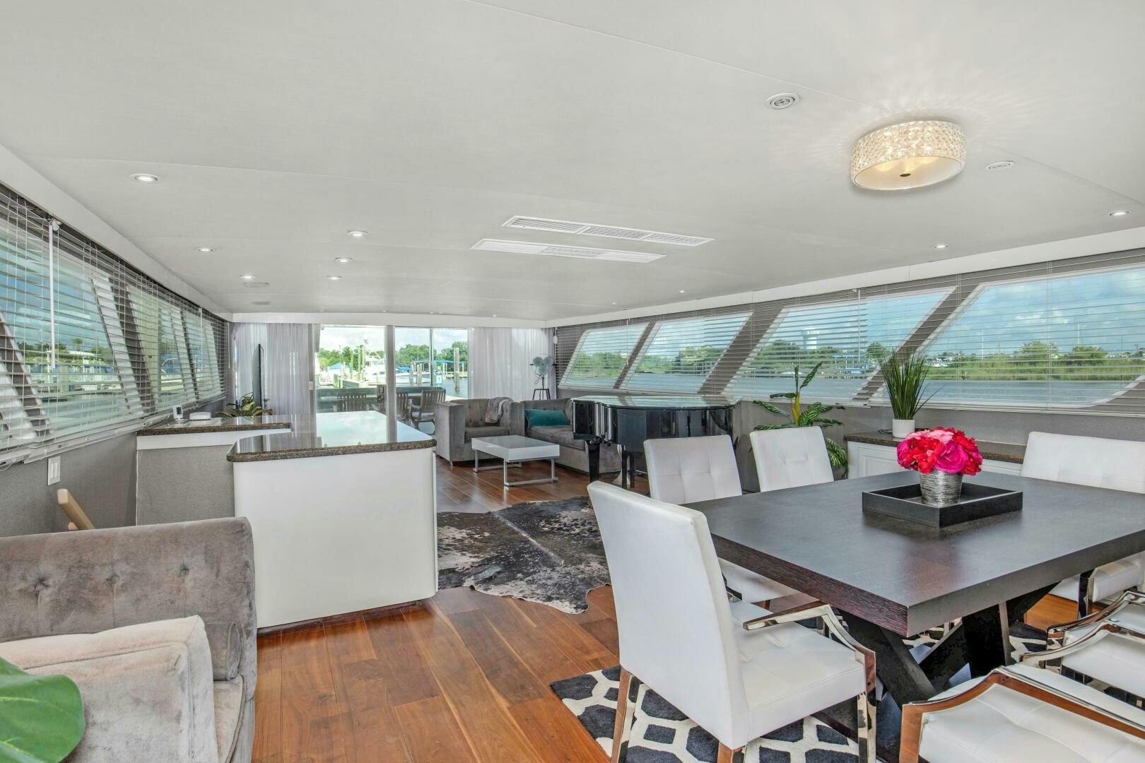 a room with a table chairs and a window aboard LADY P Yacht for Sale