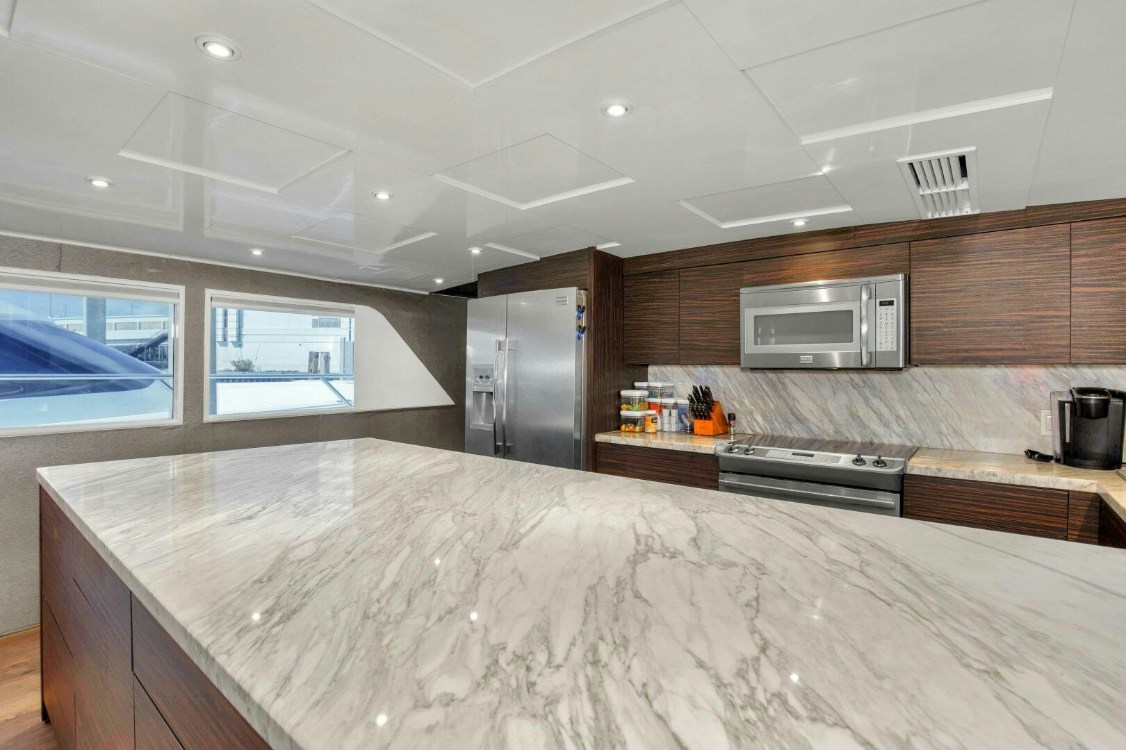 a large kitchen with a large island aboard LADY P Yacht for Sale