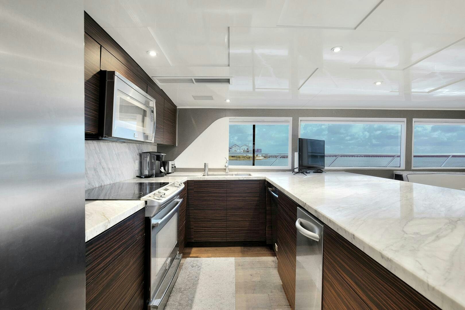 a kitchen with a large island aboard LADY P Yacht for Sale