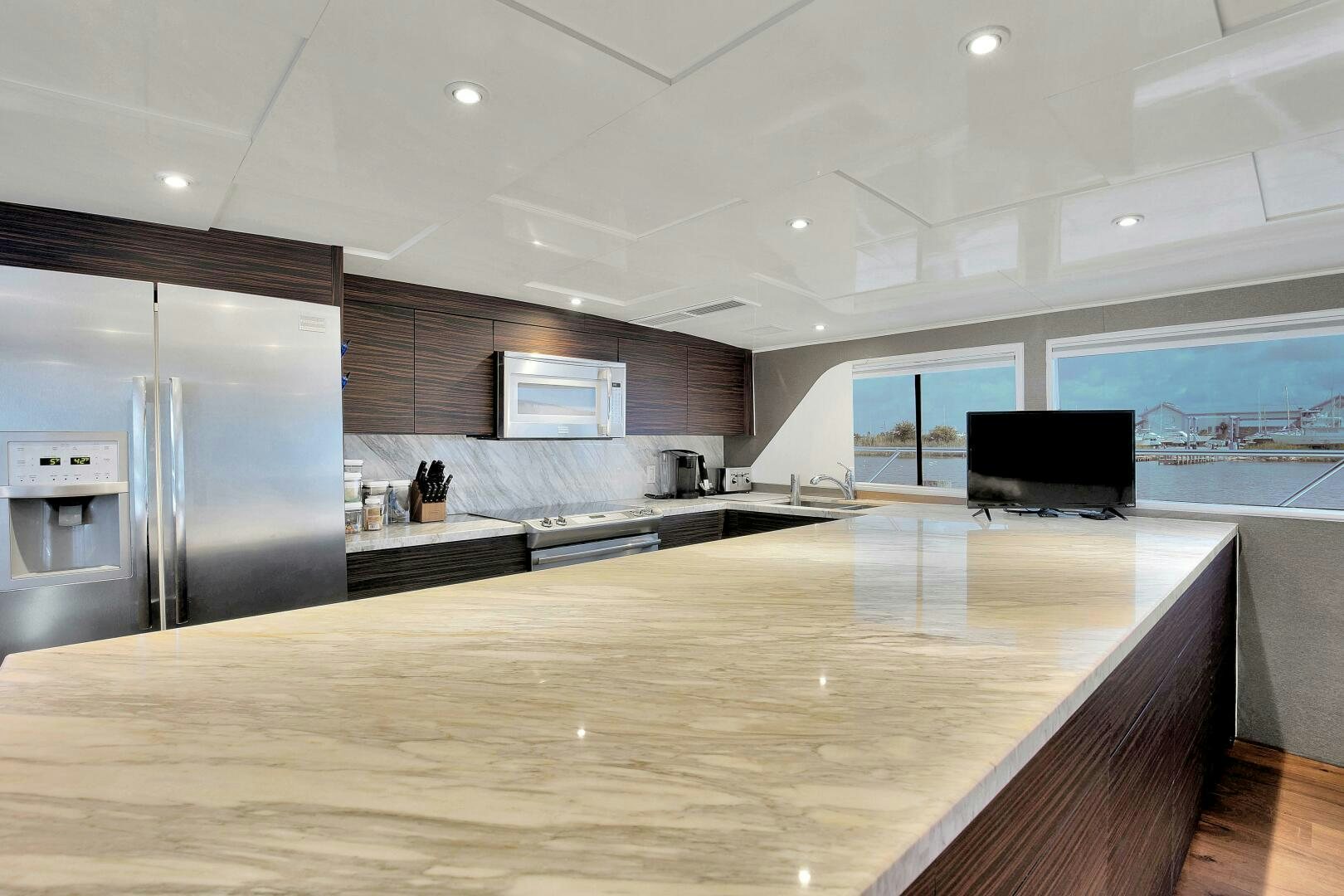 a large kitchen with a large island aboard LADY P Yacht for Sale