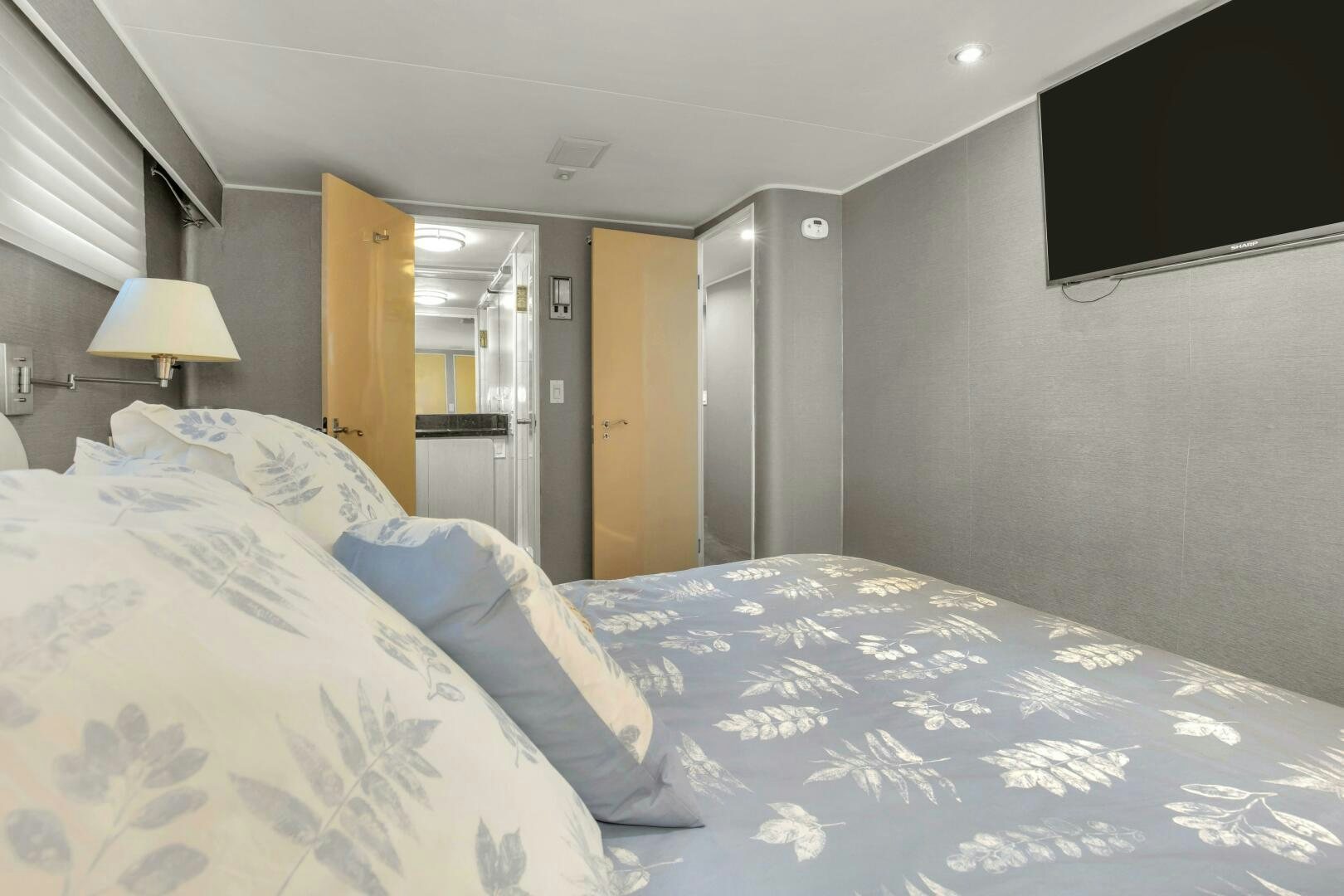 a bed with a blue comforter aboard LADY P Yacht for Sale