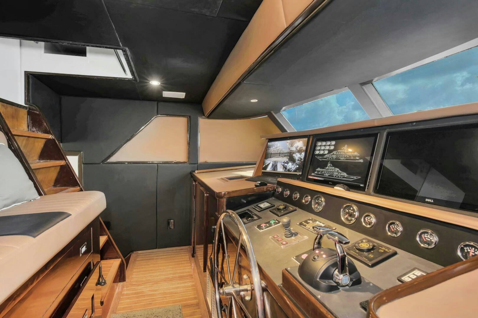 a room with a large television and a table with chairs aboard LADY P Yacht for Sale