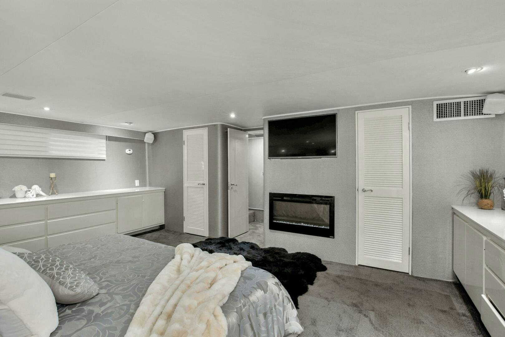 a bedroom with a bed and tv aboard LADY P Yacht for Sale