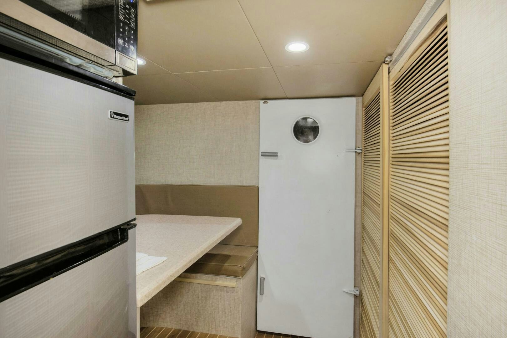 a kitchen with a fridge and a sink aboard LADY P Yacht for Sale