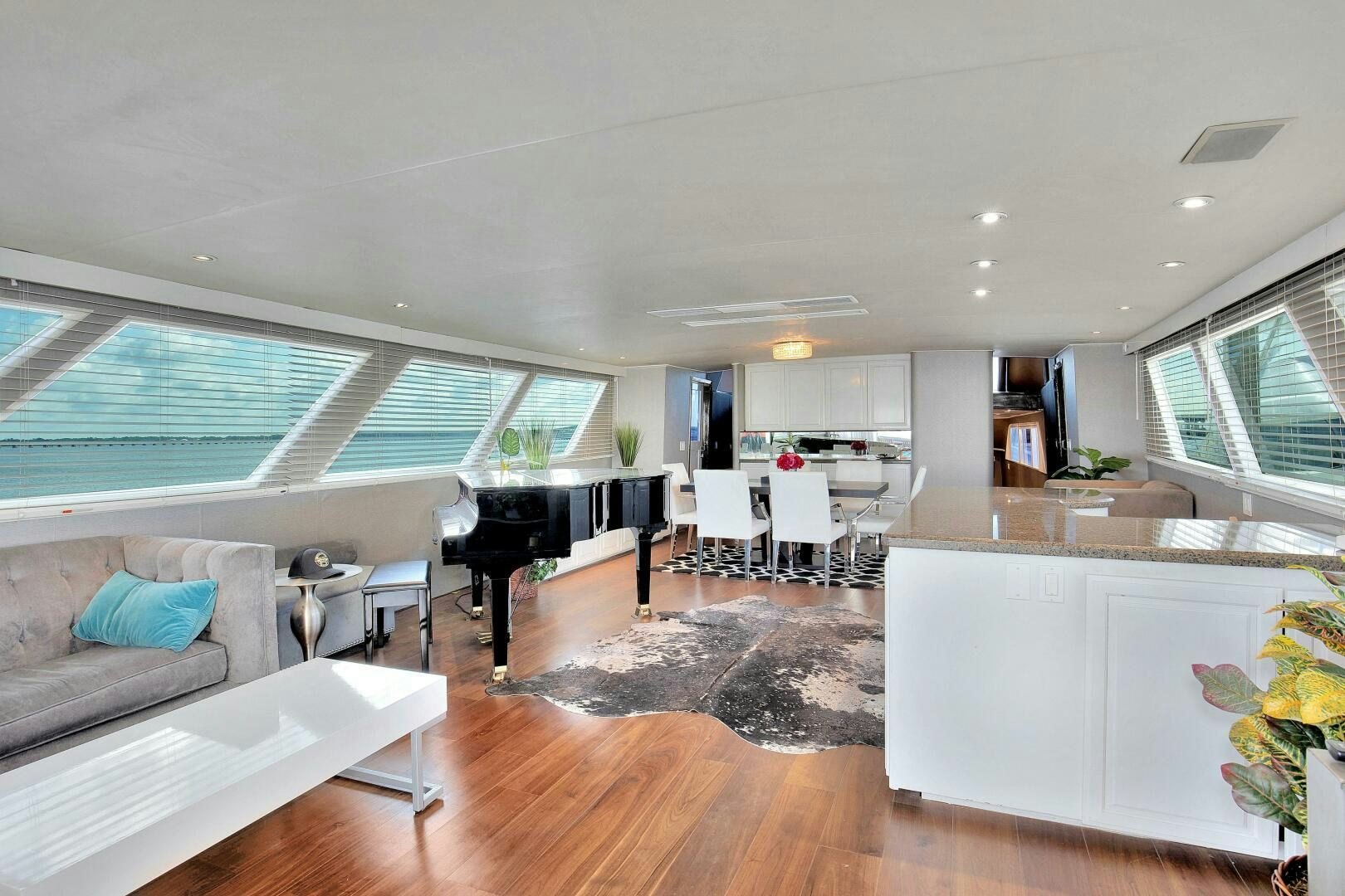 a living room with a piano aboard LADY P Yacht for Sale