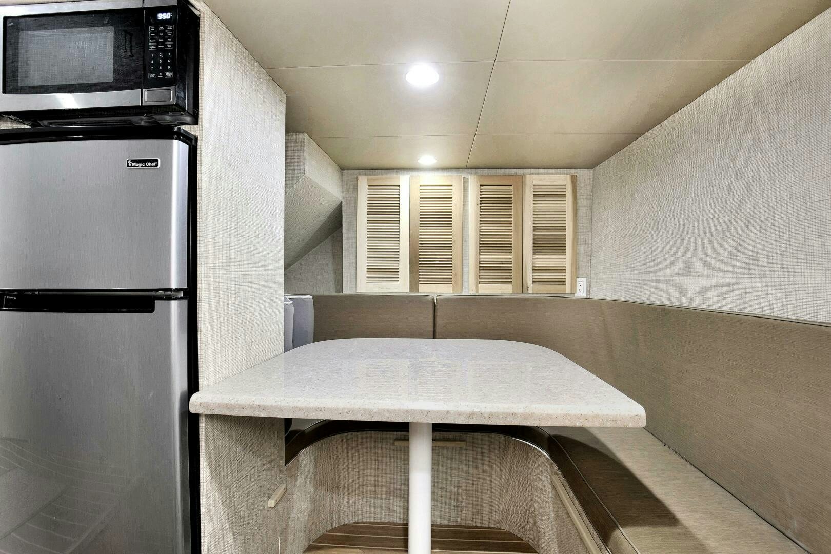 a kitchen with a table and a microwave aboard LADY P Yacht for Sale