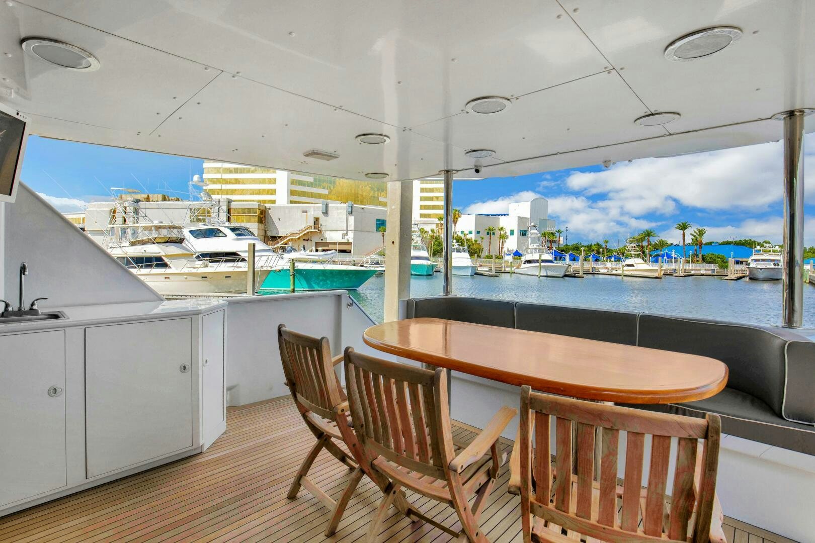 a room with a table chairs and a view of the water aboard LADY P Yacht for Sale