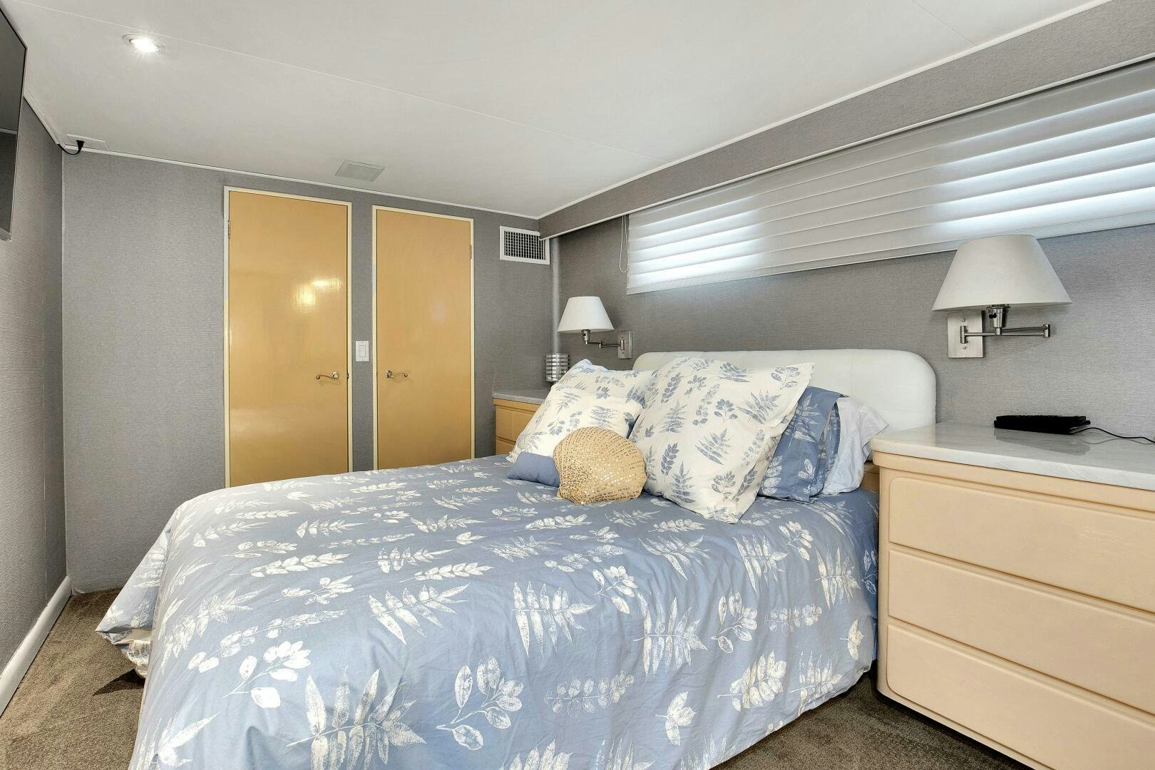 a bedroom with a bed and a desk aboard LADY P Yacht for Sale