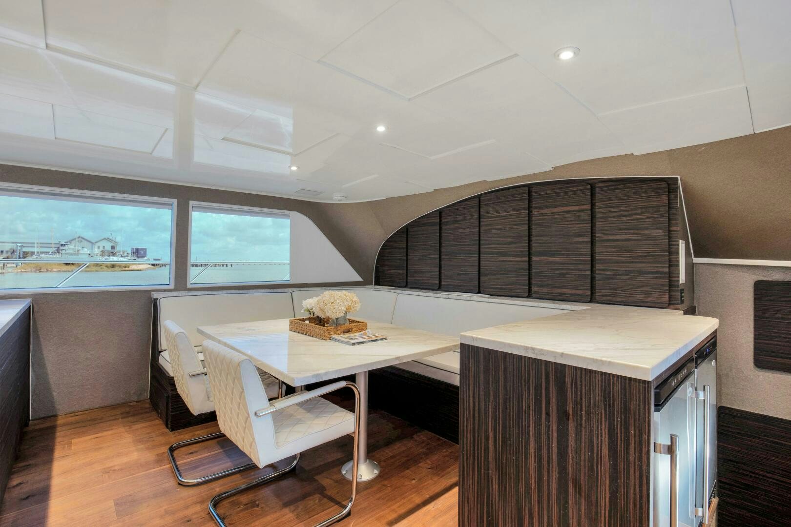 a room with a table and chairs aboard LADY P Yacht for Sale