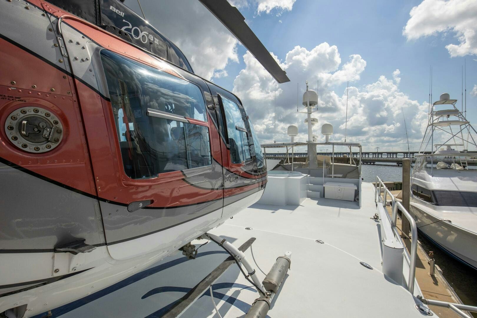 a red helicopter on a dock aboard LADY P Yacht for Sale