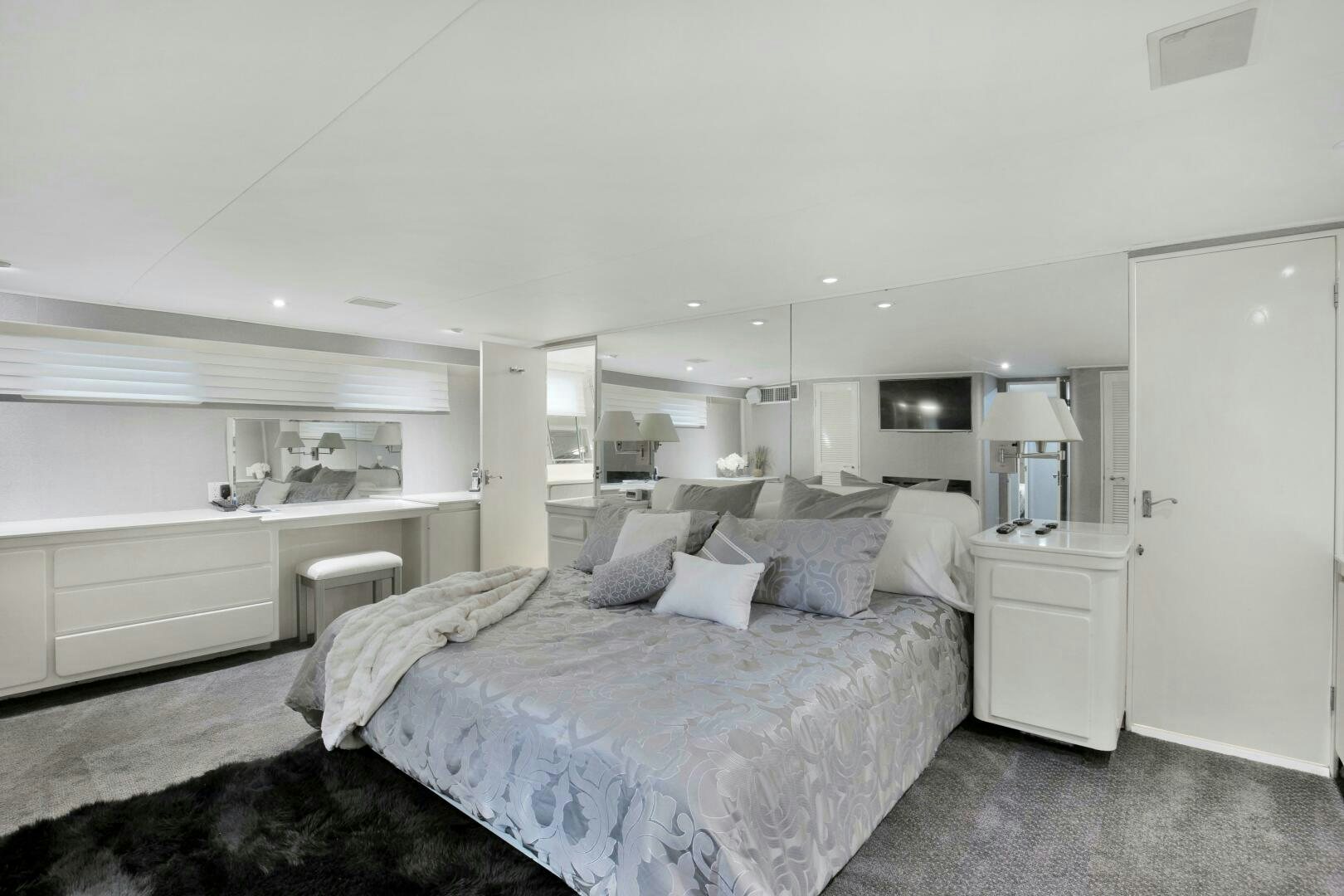 a bedroom with a bed and a desk aboard LADY P Yacht for Sale