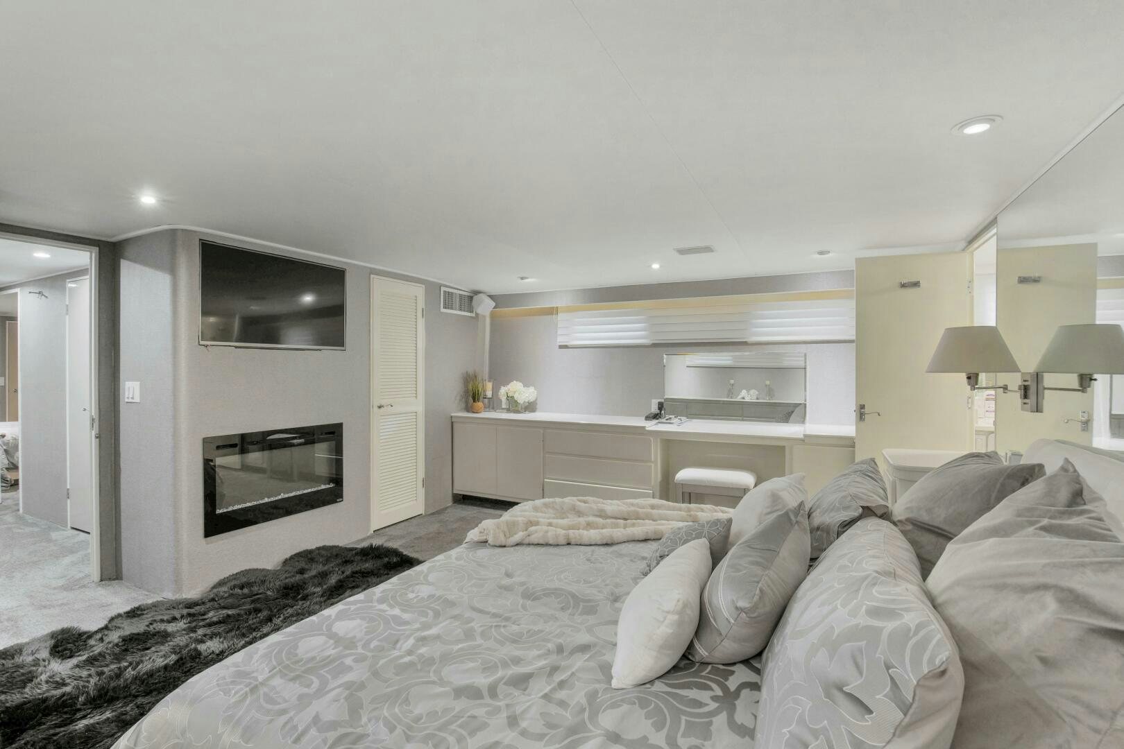 a bedroom with a bed and a television aboard LADY P Yacht for Sale