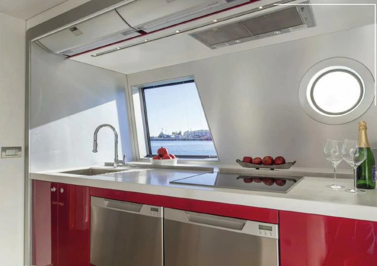 a kitchen with red cabinets aboard NAVCAT Yacht for Sale