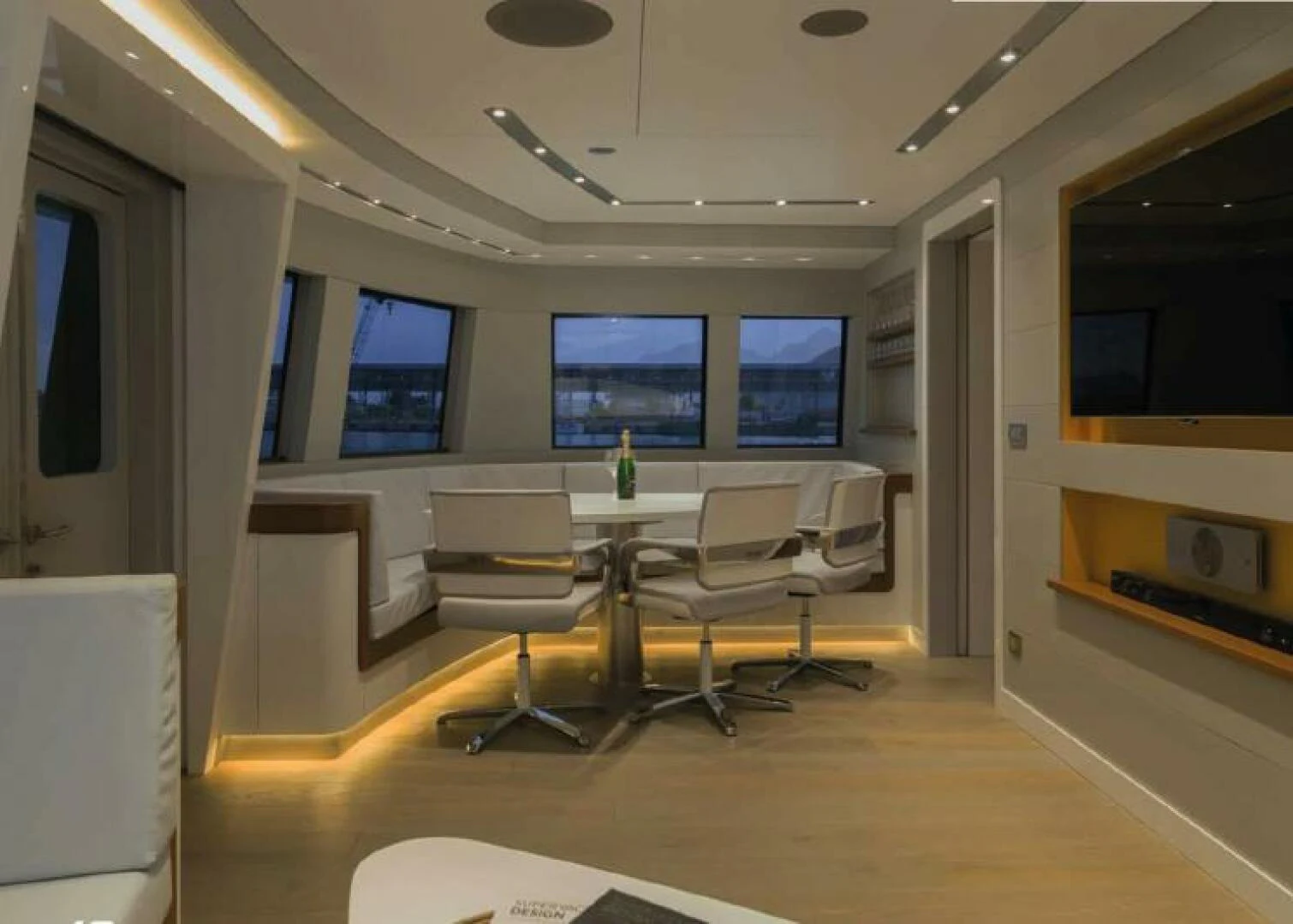 a room with a table and chairs aboard NAVCAT Yacht for Sale