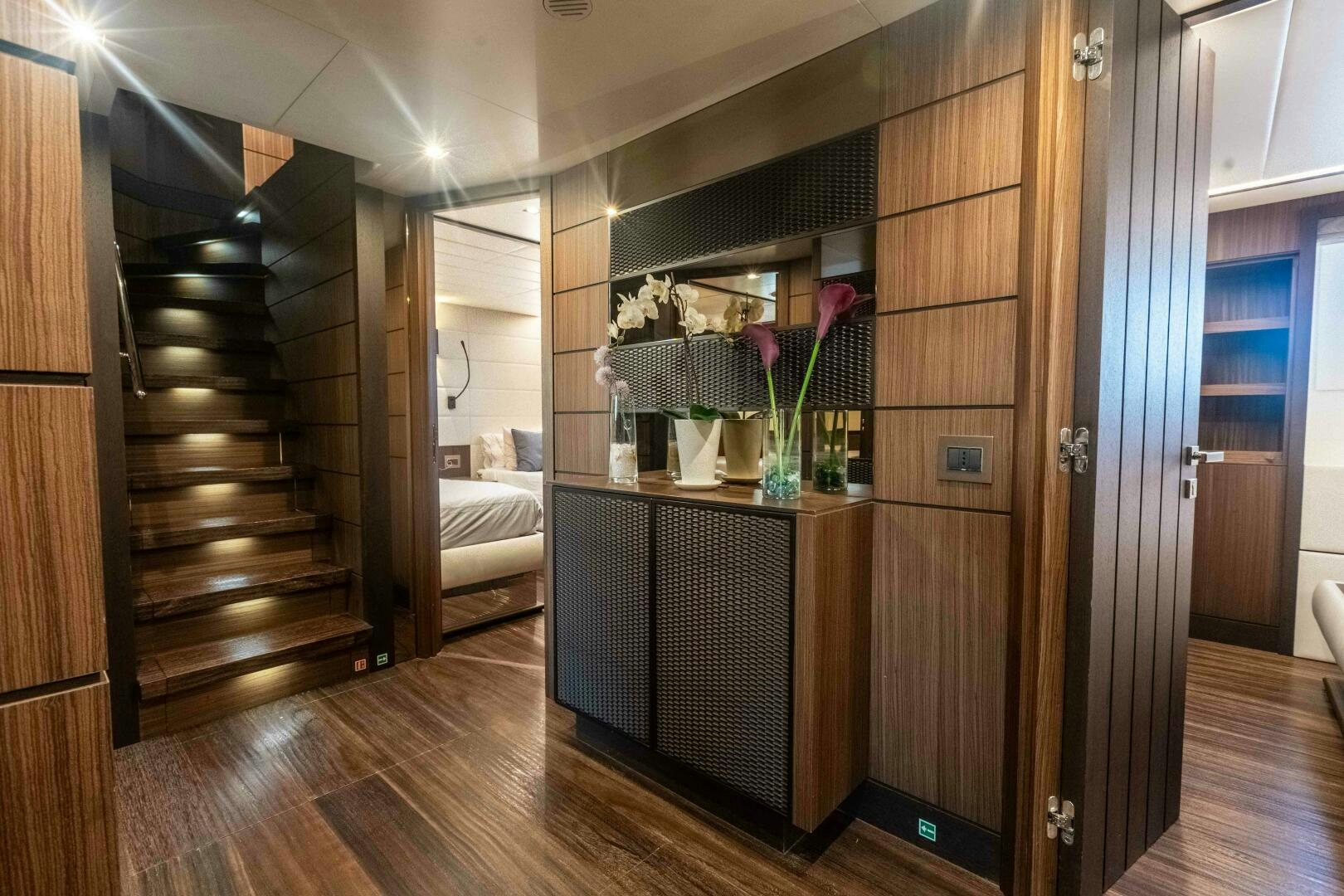 a room with a wood cabinet and shelves with flowers on it aboard SAFAD Yacht for Sale