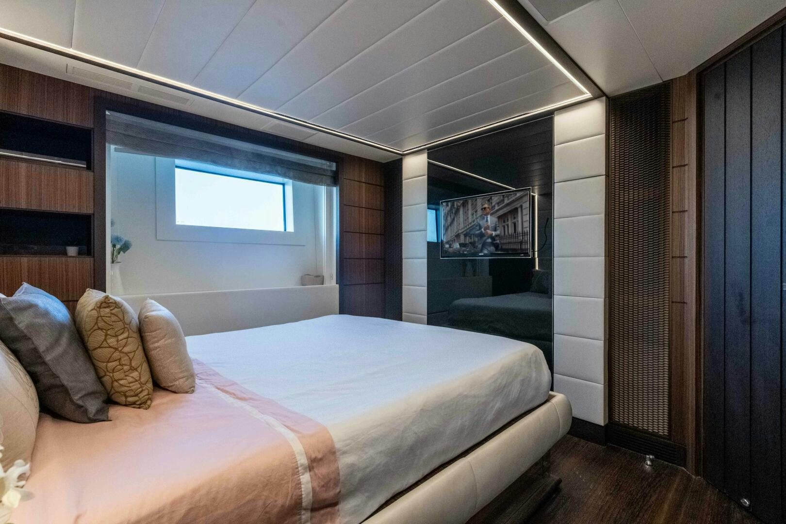 a bedroom with a bed and a window aboard SAFAD Yacht for Sale