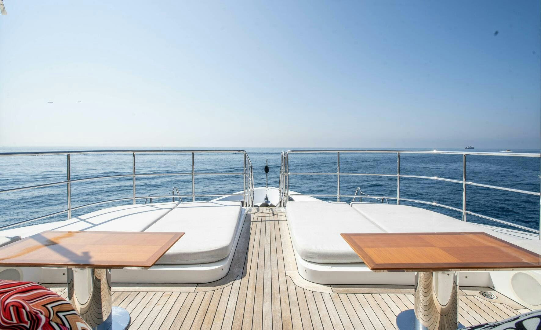 a deck with chairs and a body of water in the background aboard SAFAD Yacht for Sale
