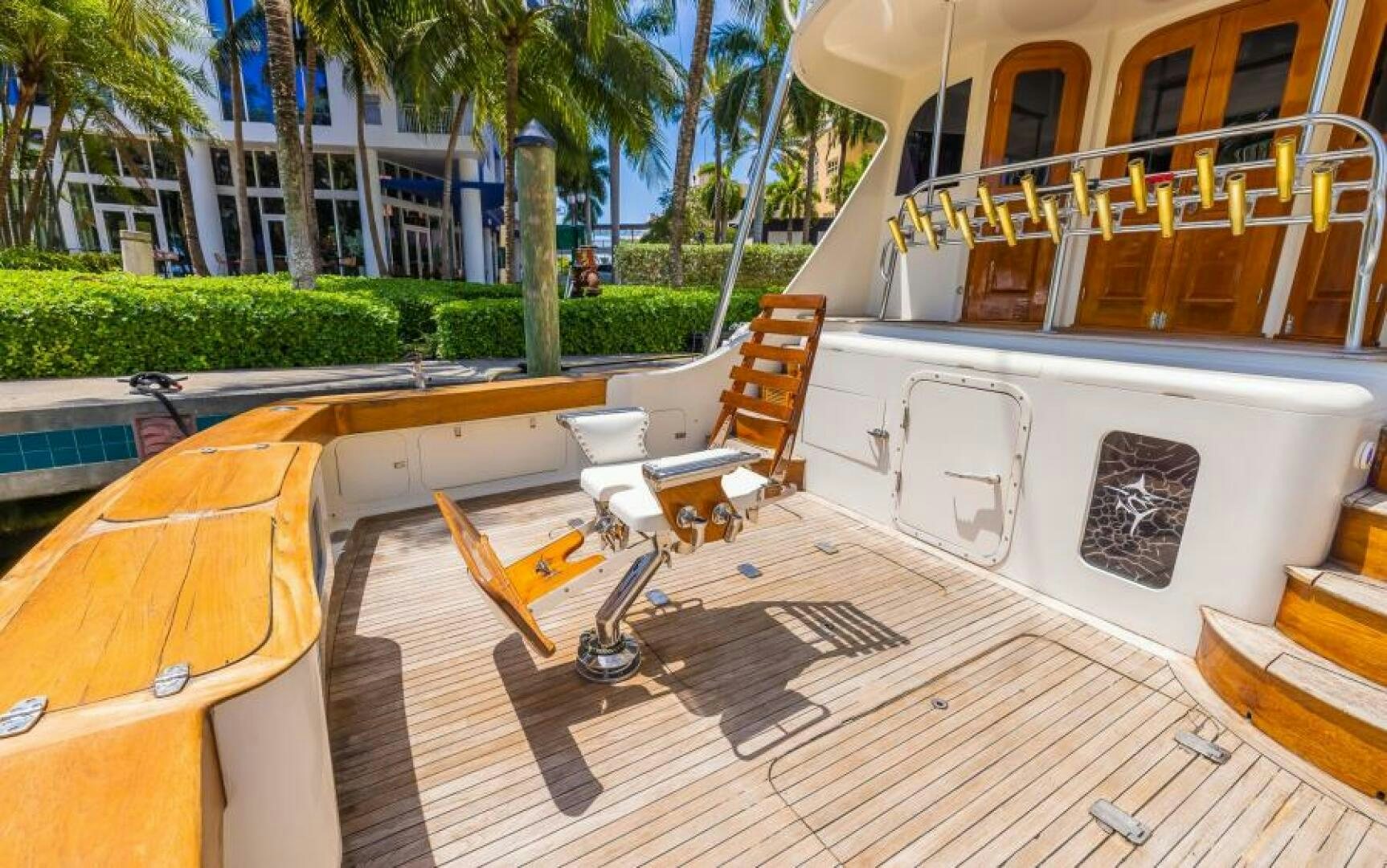 a deck with chairs and tables aboard BOOMER Yacht for Sale