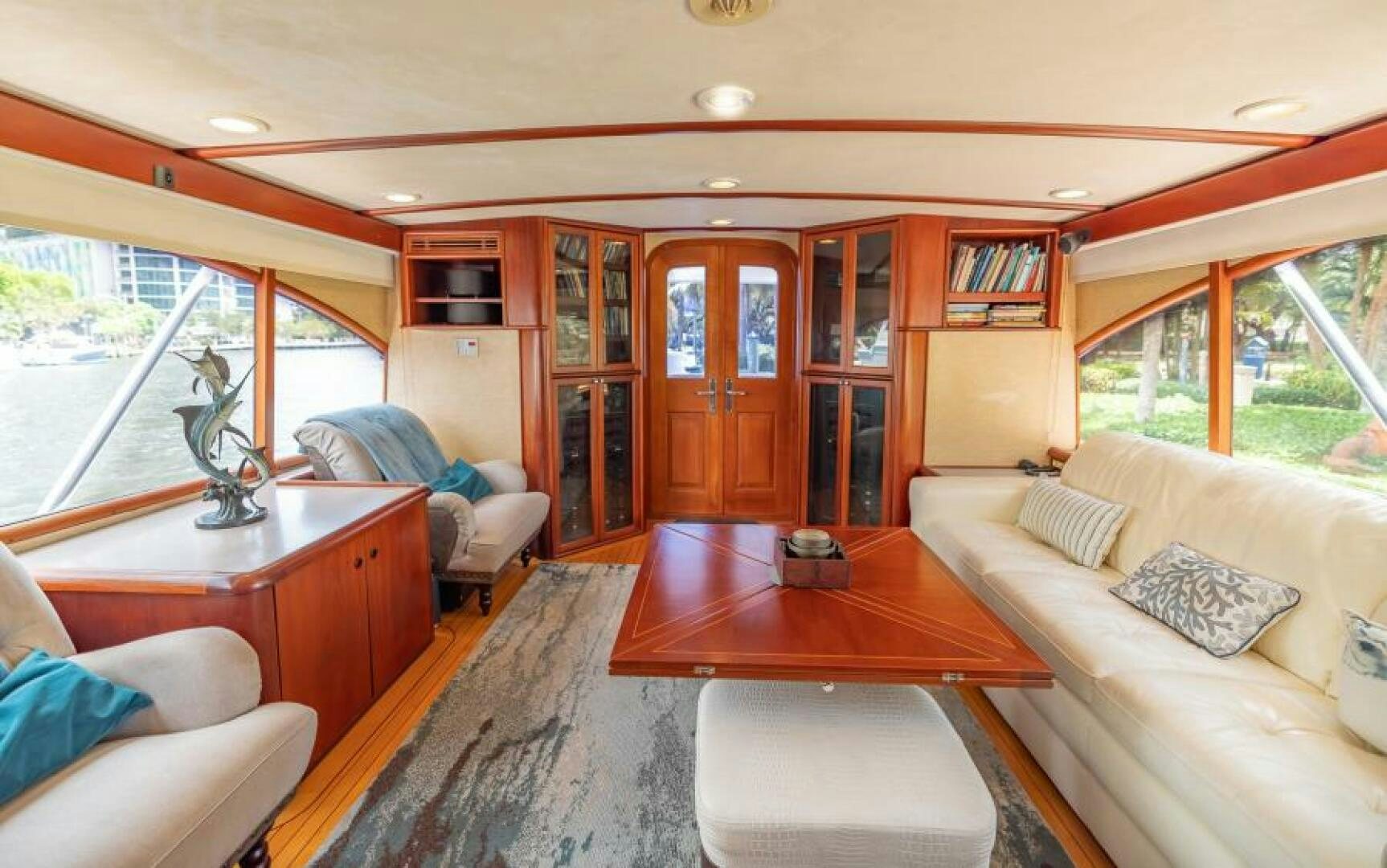 a living room with a table and couches aboard BOOMER Yacht for Sale