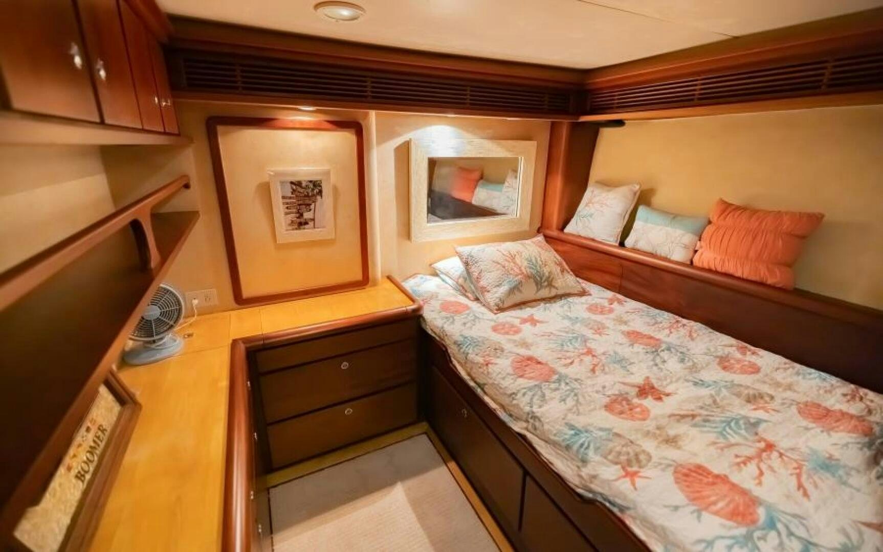 a bedroom with a bed and a desk aboard BOOMER Yacht for Sale